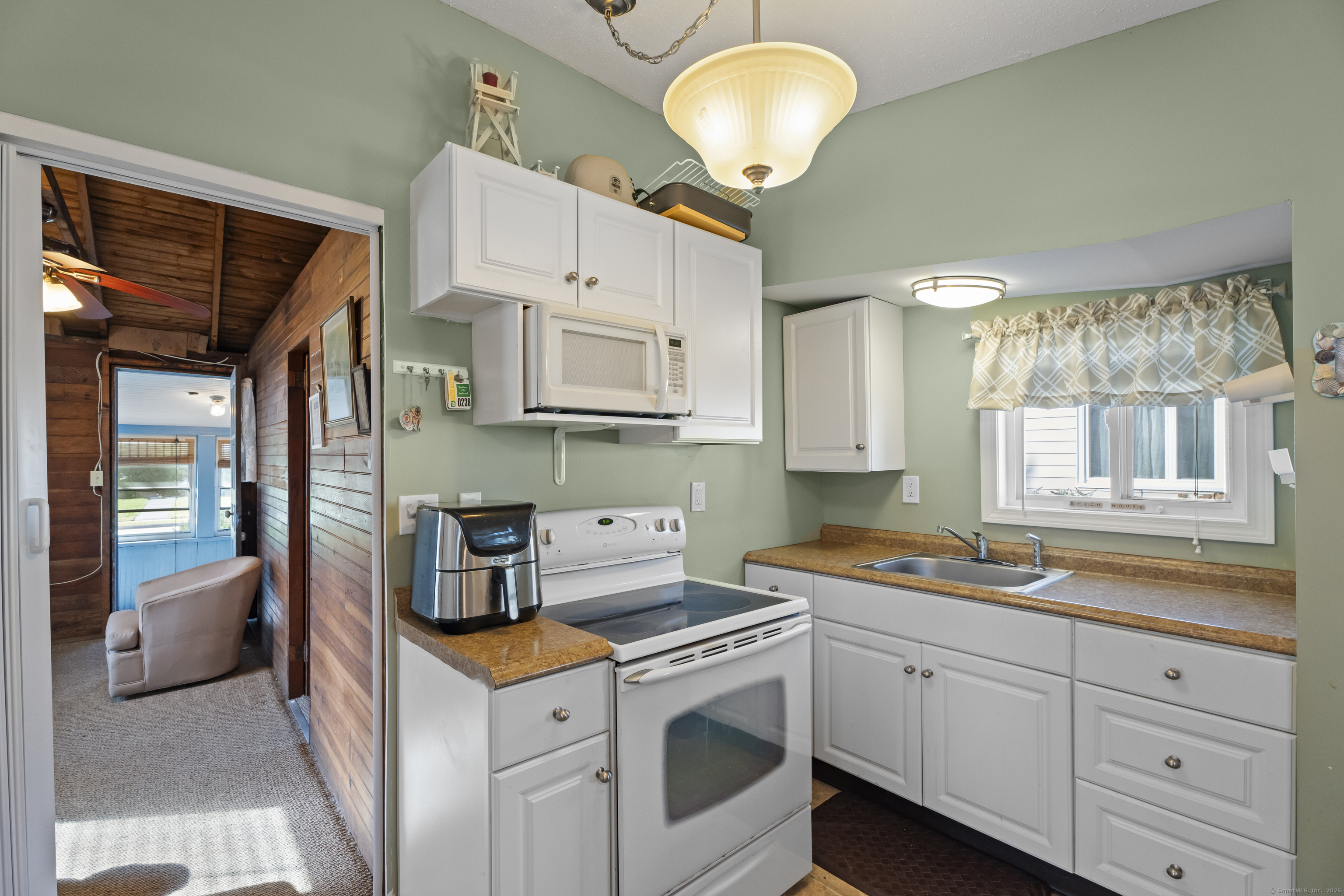 13 College Street Old Saybrook, CT 06475 - Photo 5 of 23 a kitchen with stainless steel appliances granite countertop a sink and cabinets