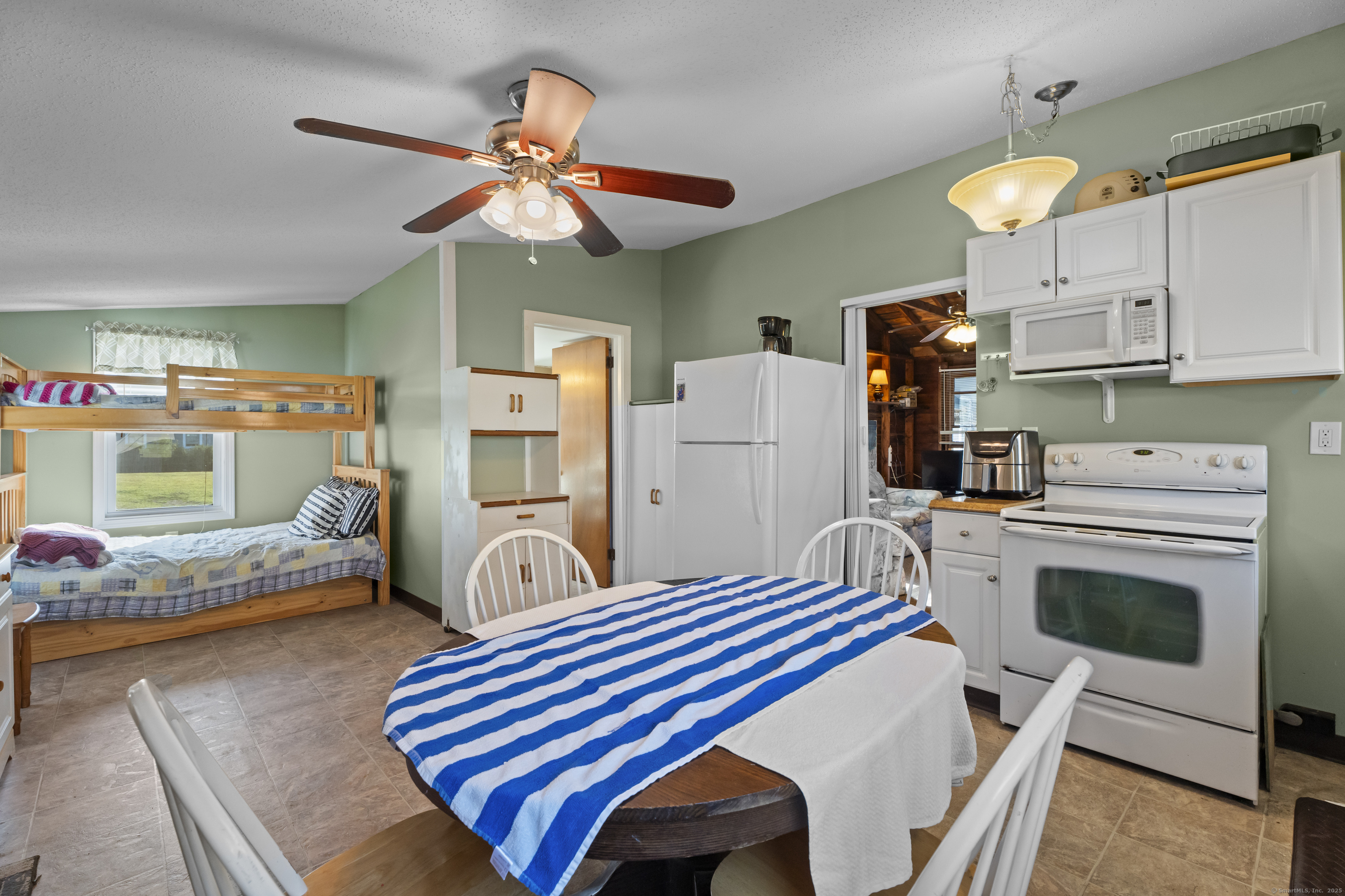13 College Street Old Saybrook, CT 06475 - Photo 7 of 23 a bedroom with furniture and a fireplace