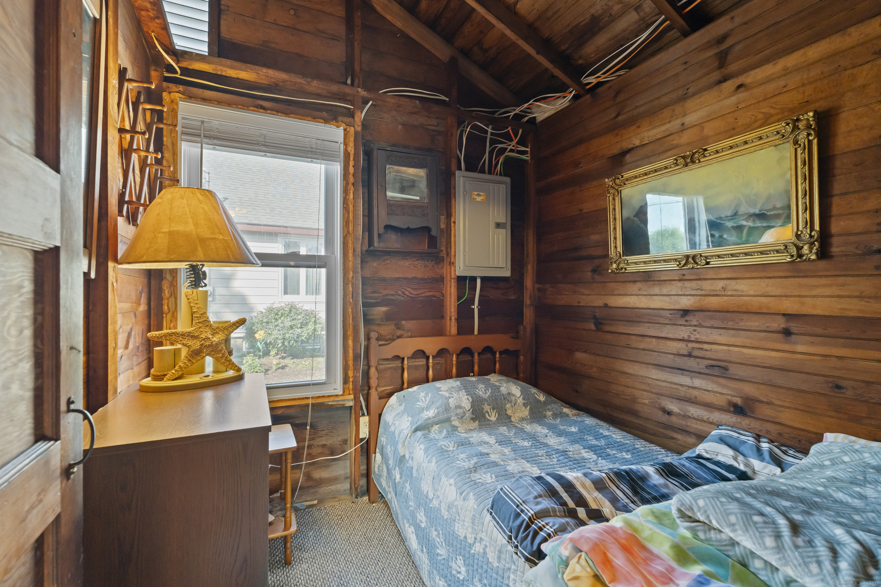 13 College Street Old Saybrook, CT 06475 - Photo 8 of 23 a bedroom with wooden floor and a window