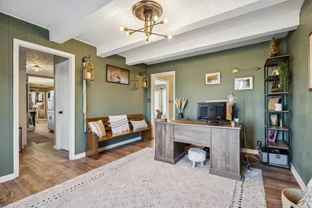 a view of a livingroom with workspace and a window