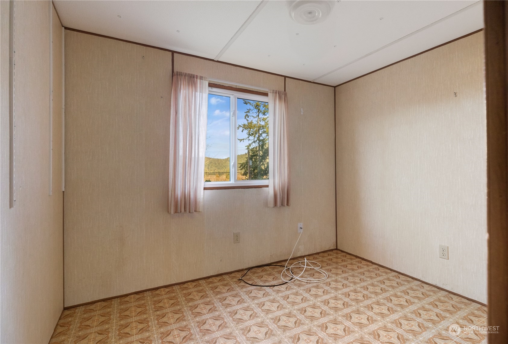 4768 Sharpe Road Anacortes, WA 98221 - Photo 17 of 37 a view of an empty room with a window
