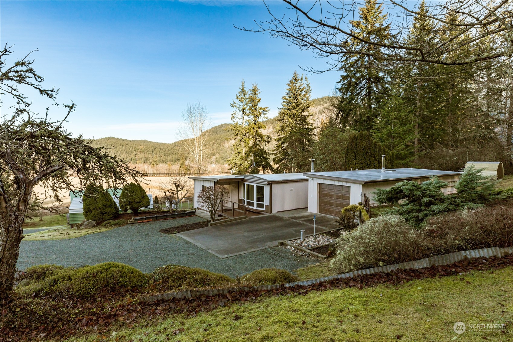 4768 Sharpe Road Anacortes, WA 98221 - Photo 19 of 37 a view of a house with a yard