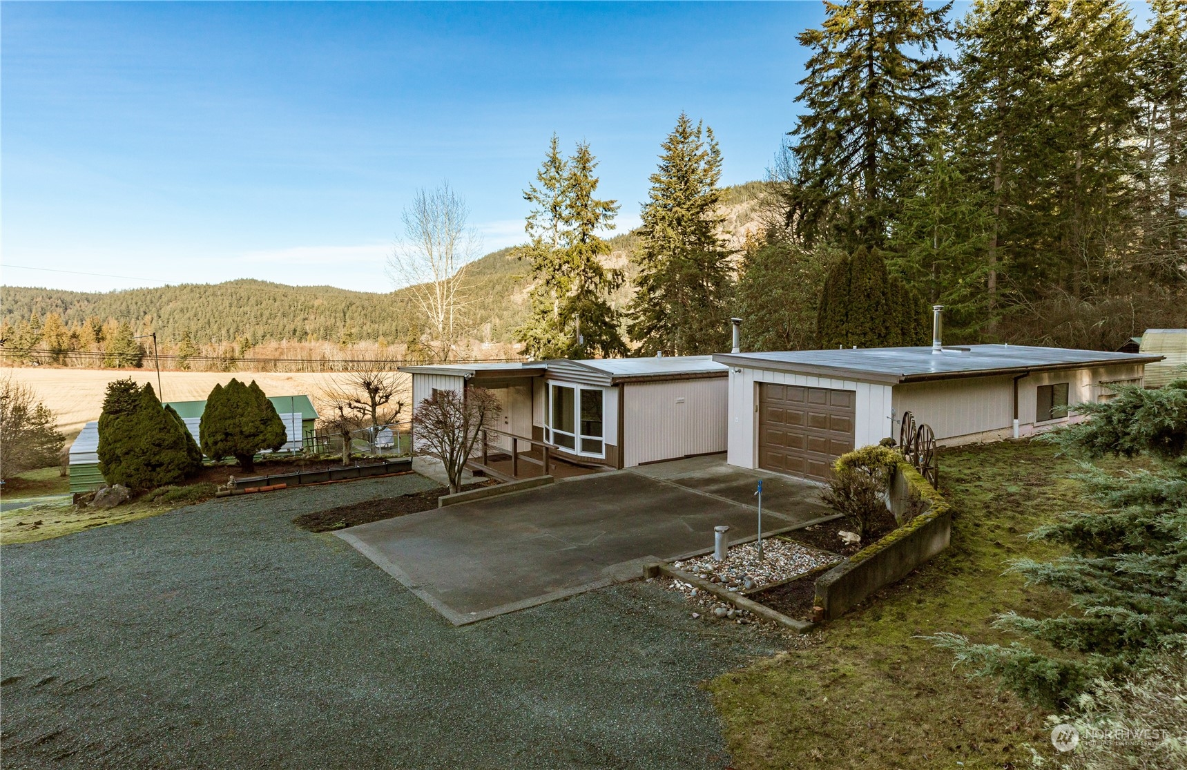 4768 Sharpe Road Anacortes, WA 98221 - Photo 29 of 37 a view of a patio with table and chairs with wooden floor and fence