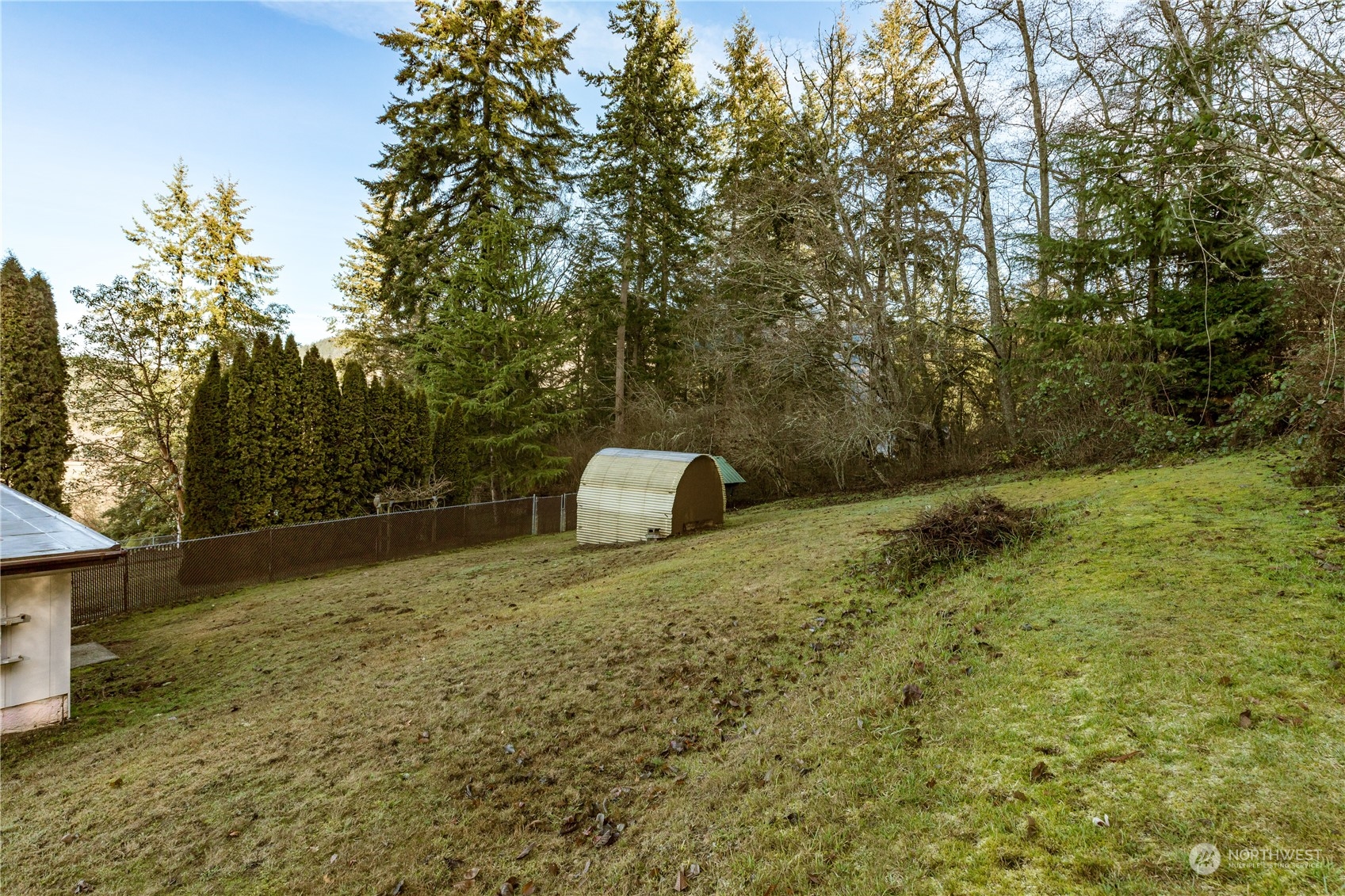 4768 Sharpe Road Anacortes, WA 98221 - Photo 31 of 37 a backyard of a house with lots of green space
