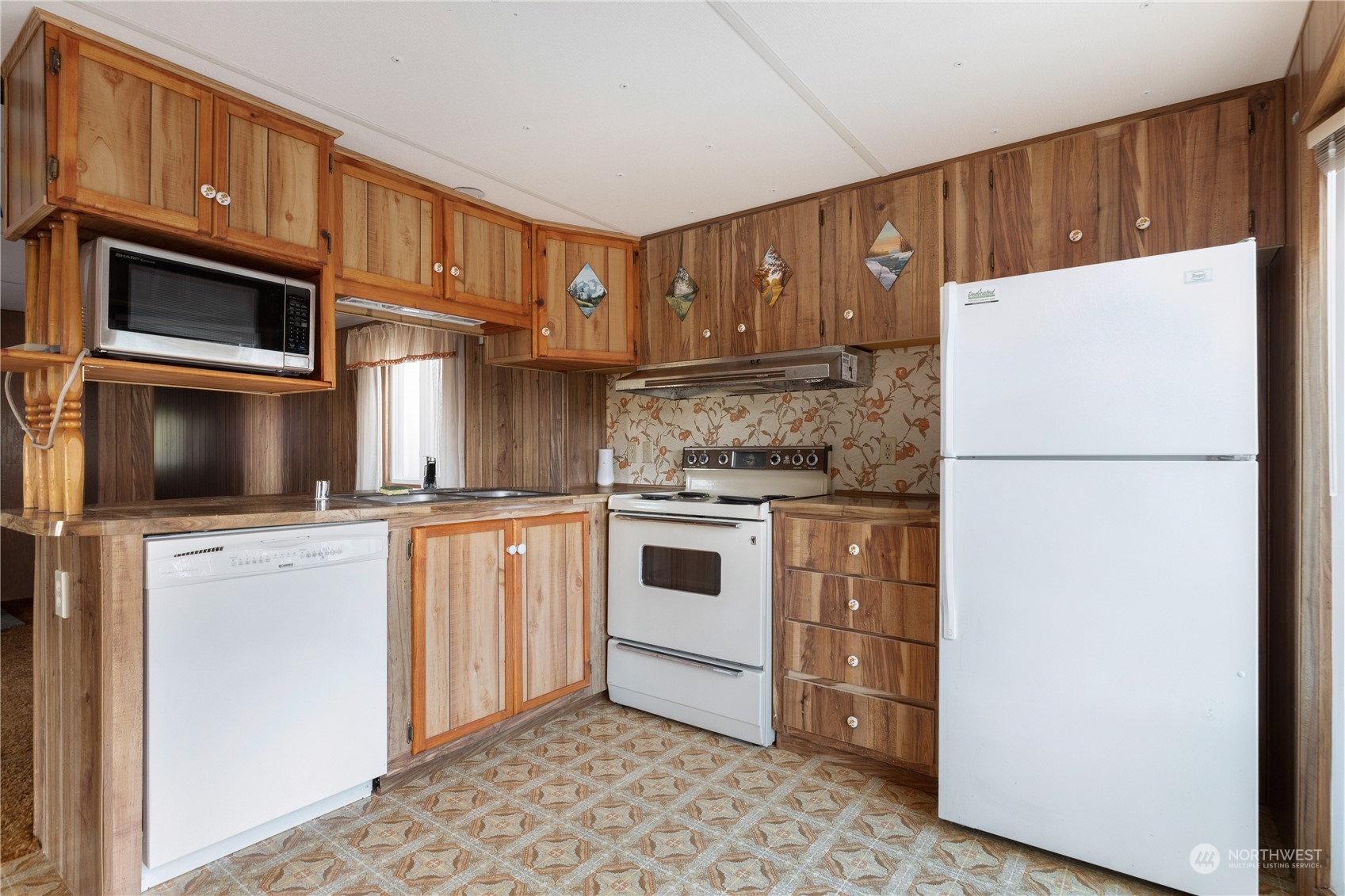 4768 Sharpe Road Anacortes, WA 98221 - Photo 7 of 37 a kitchen with stainless steel appliances granite countertop a refrigerator a stove a sink and a microwave