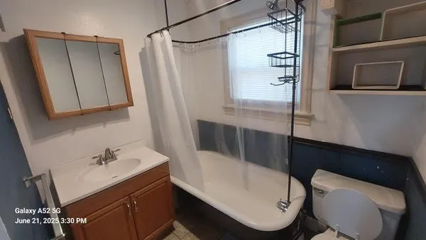 a bathroom with a sink a toilet a shower and bathtub