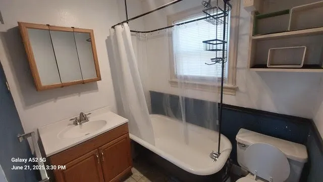 a bathroom with a sink a toilet a shower and bathtub