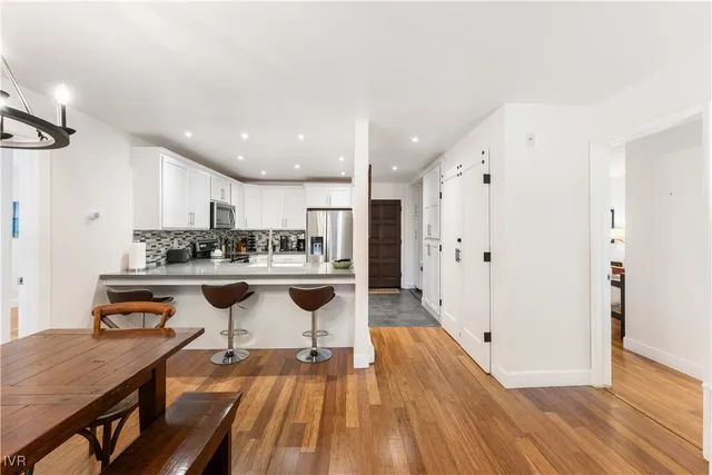 a open kitchen with stainless steel appliances granite countertop a sink and a refrigerator
