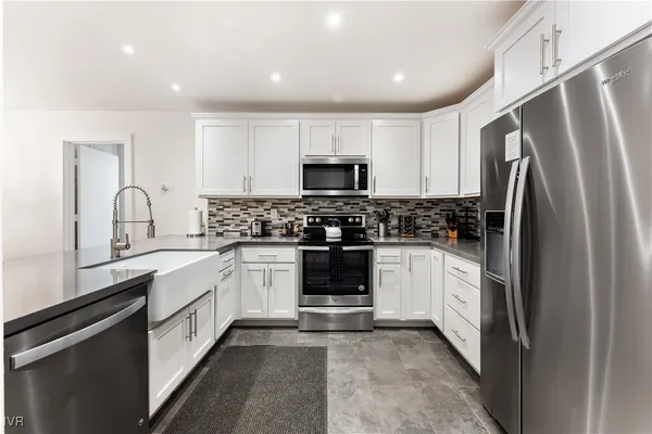 a kitchen with a refrigerator and a stove top oven