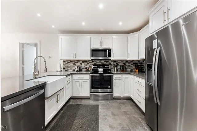 a kitchen with a refrigerator and a stove top oven