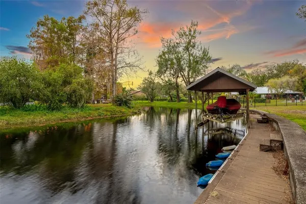 a view of a lake with a garden and trees