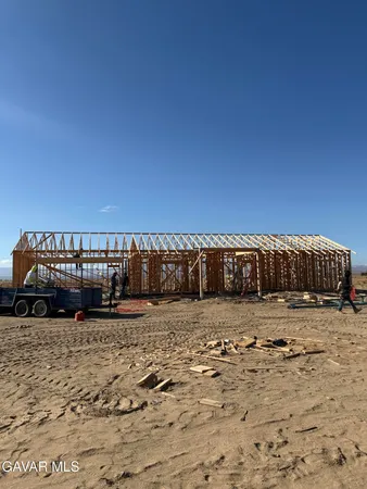 a view of a parking space with wooden fence