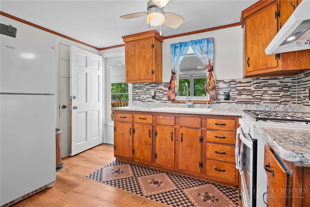 154 Folger Road Sparta, NC 28675 - Photo 6 of 37 a kitchen with stainless steel appliances granite countertop a refrigerator and a stove