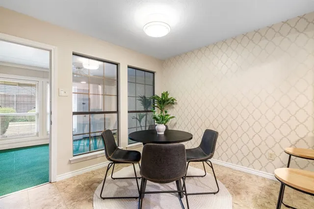 a dining room with furniture and window