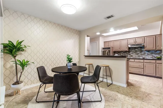 a kitchen with a table and chairs in it