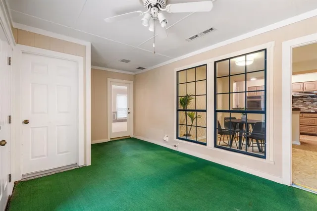 a view of an empty room with a window and closet