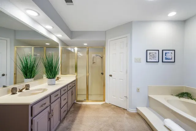 a bathroom with a tub sink and mirror