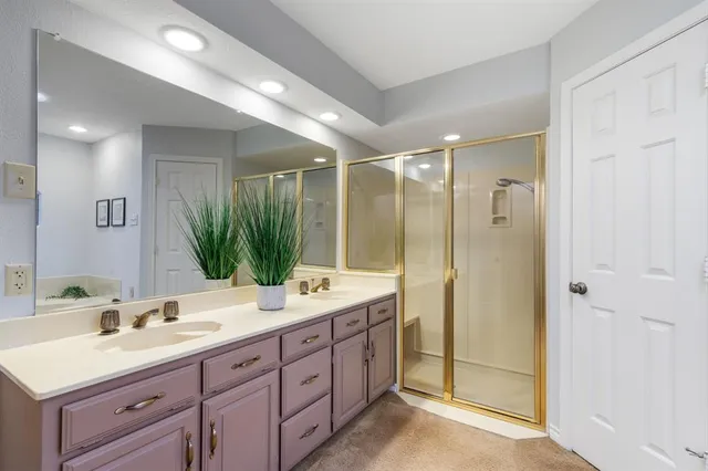 a bathroom with double sink and a mirror