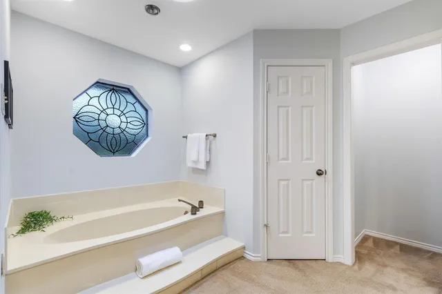 a bathroom with a bathtub and a shower