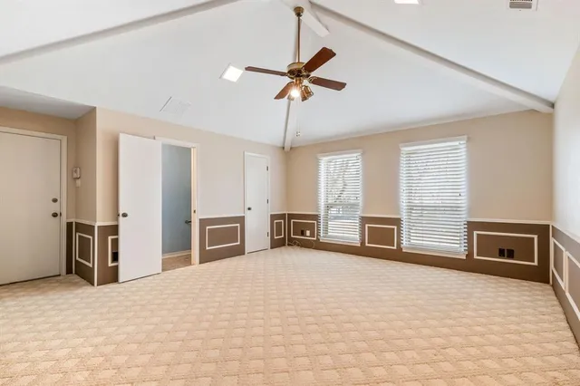 a view of a livingroom with wooden floor and furniture