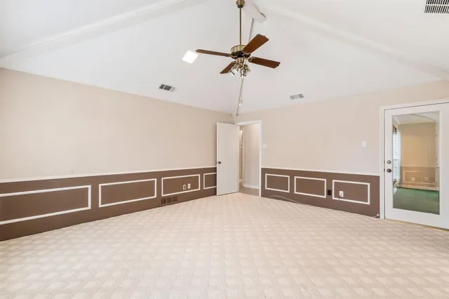 a view of an empty room with a ceiling fan