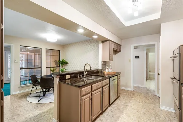 a kitchen with stainless steel appliances granite countertop a stove and a refrigerator