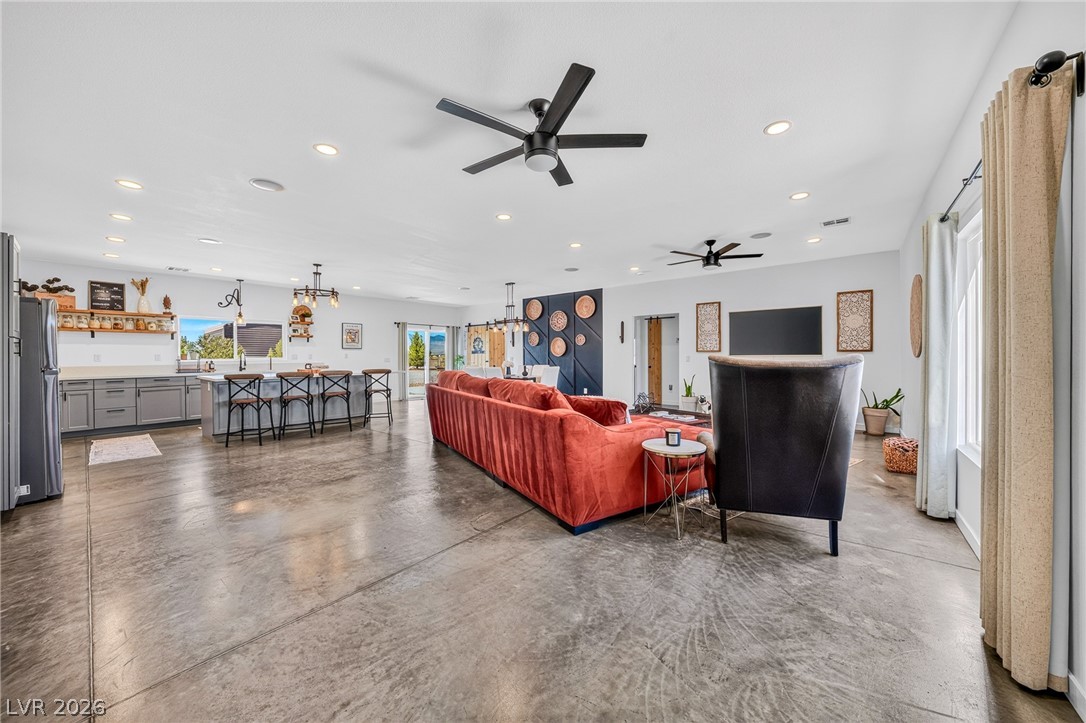 4080 Magnet Road Pahrump, NV 89048 - Photo 7 of 28 Polished concrete floors and high ceilings define this spacious, open-concept living area.
