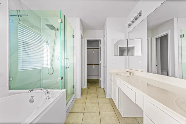 a bathroom with a tub sink and mirror