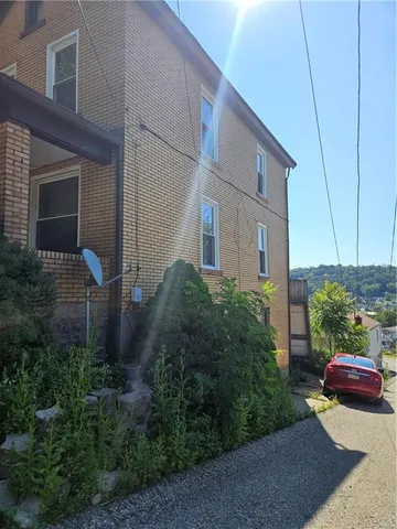 a backyard of a house with plants and outdoor seating