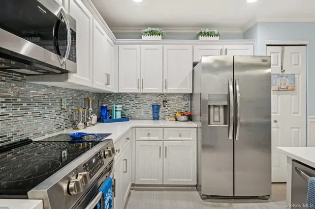 a kitchen with stainless steel appliances granite countertop a refrigerator sink and stove