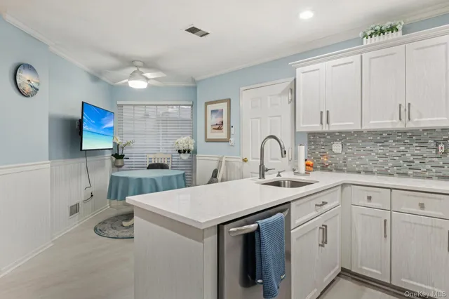 a kitchen with a sink cabinets and appliances