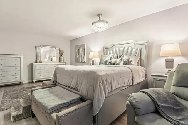 a bedroom with a bed and a chandelier