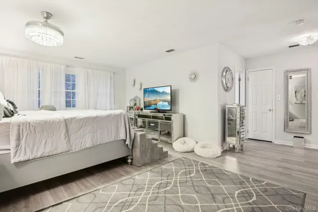 a bedroom with a bed and a television