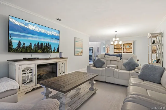 a living room with furniture fireplace and flat screen tv