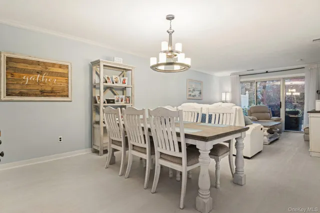 a dining room with furniture a chandelier and window