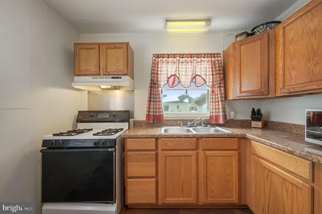 a kitchen with stainless steel appliances granite countertop a stove and a sink