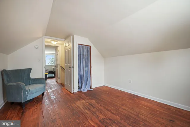 a view of a livingroom with wooden floor and furniture