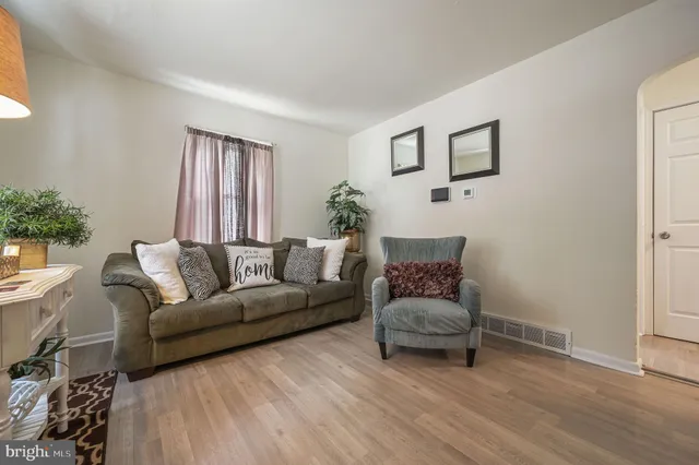 a living room with furniture and a potted plant
