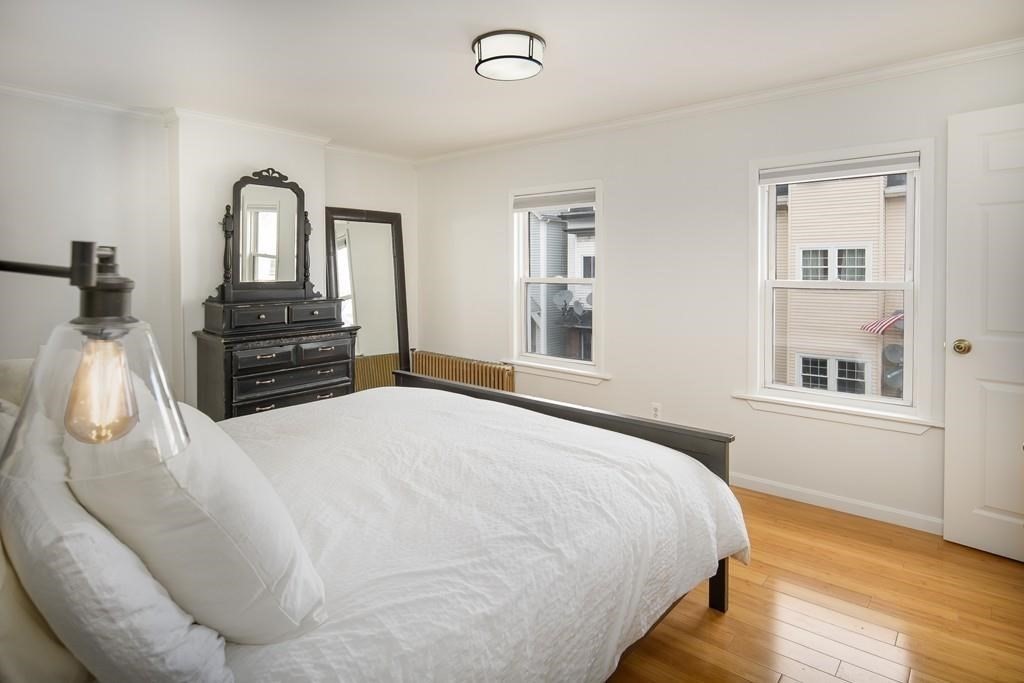 144 Brooks Street Boston, MA 02128 - Photo 11 of 20 a bedroom with a bed and wooden floor