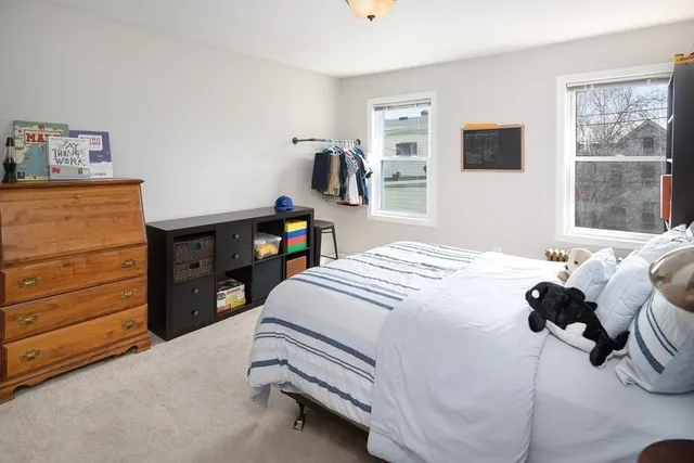 a bedroom with a bed and a tv on the dresser