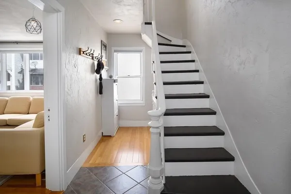 a view of entryway and hall with wooden floor