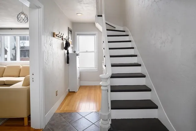 a view of entryway and hall with wooden floor