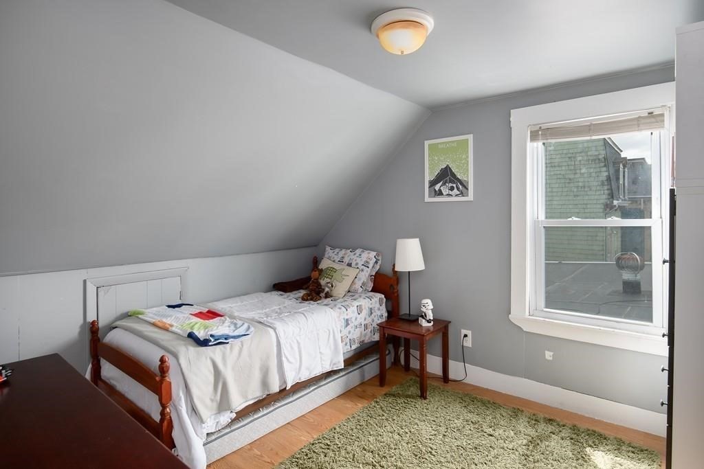 144 Brooks Street Boston, MA 02128 - Photo 8 of 20 a bedroom with a bed and window