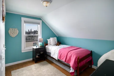 a bedroom with a bed and window