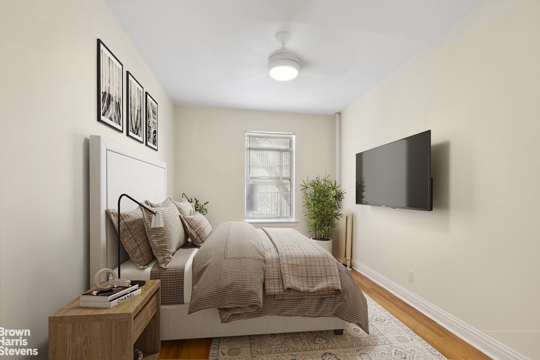 515 Edgecombe Avenue, Unit 41 Manhattan, NY 10032 - Photo 5 of 12 a bedroom with a bed and a flat screen tv