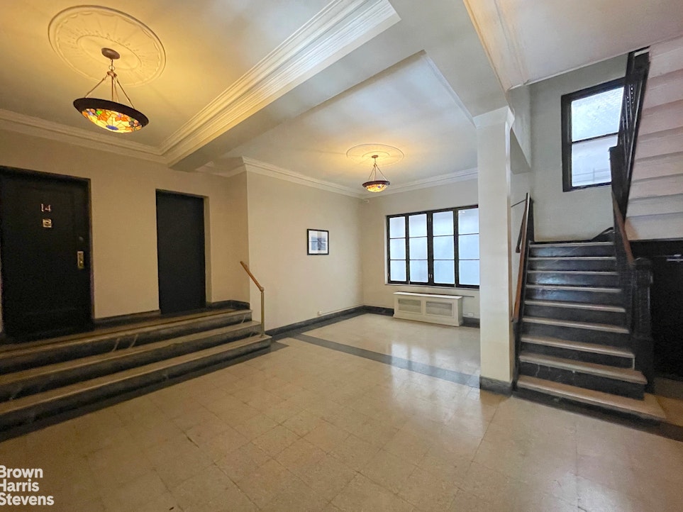 515 Edgecombe Avenue, Unit 41 Manhattan, NY 10032 - Photo 9 of 12 en empty room with windows and ceiling fan
