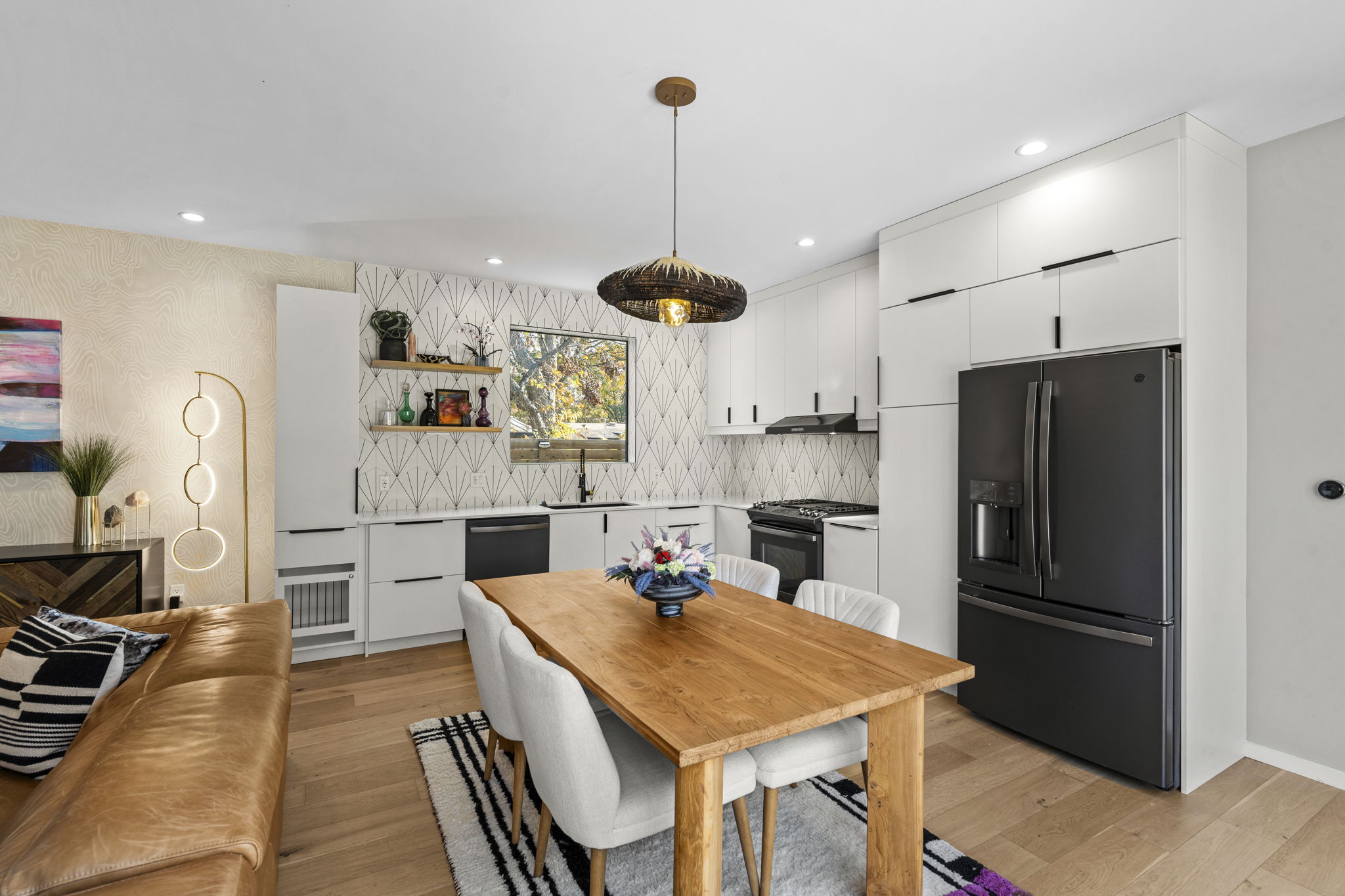 7525 Delafield Lane, Unit B Austin, TX 78752 - Photo 13 of 37 a kitchen with stainless steel appliances kitchen island granite countertop a refrigerator a stove a sink a dining table and chairs with wooden floor