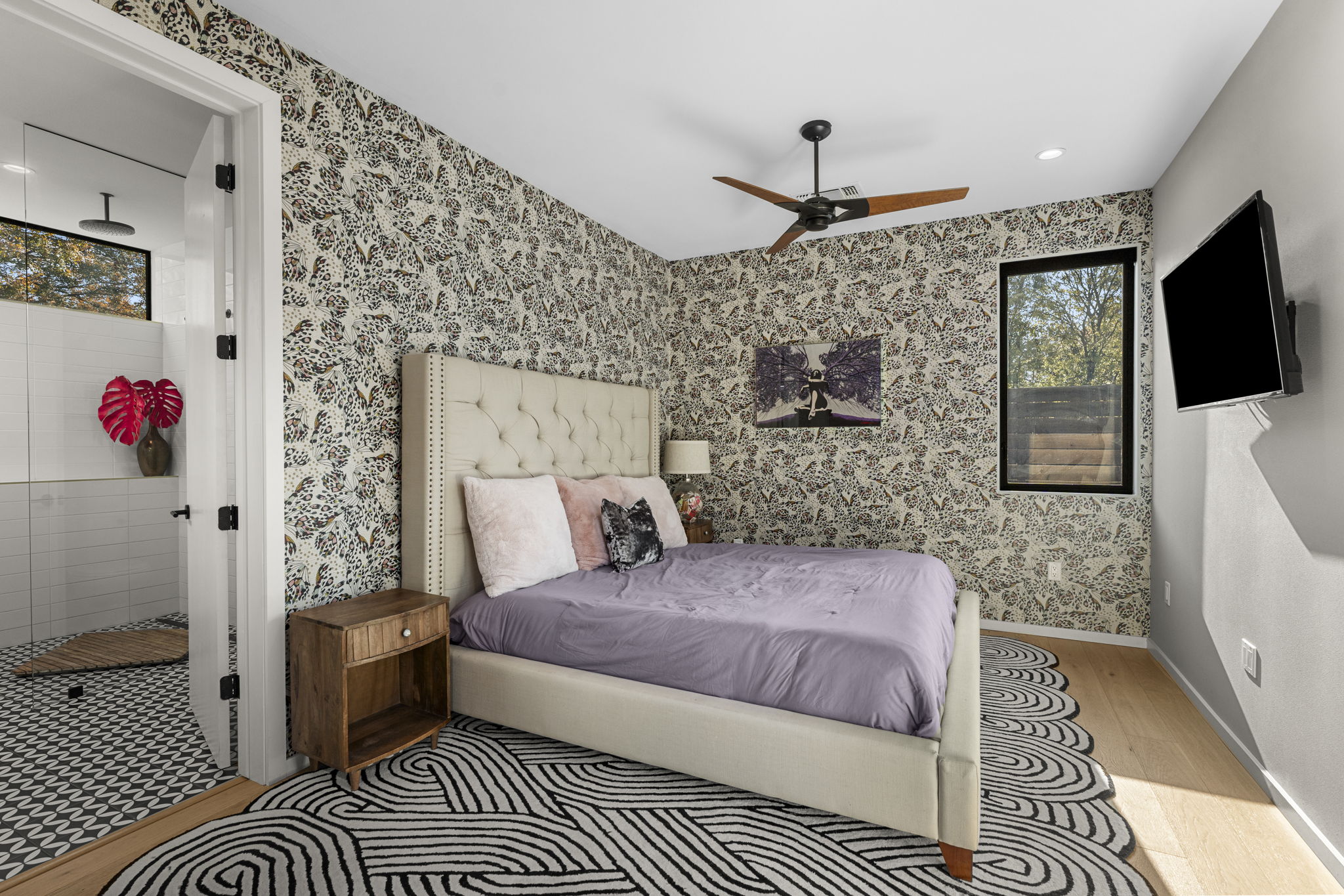 7525 Delafield Lane, Unit B Austin, TX 78752 - Photo 15 of 37 a bedroom with a bed and a flat screen tv