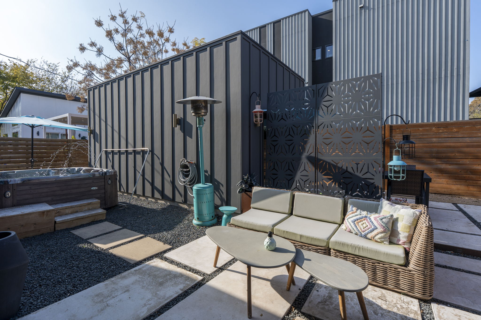 7525 Delafield Lane, Unit B Austin, TX 78752 - Photo 21 of 37 a backyard of a house with barbeque oven table and chairs