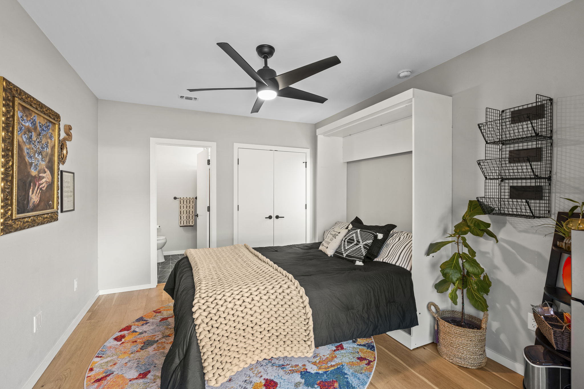 7525 Delafield Lane, Unit B Austin, TX 78752 - Photo 31 of 37 a bedroom with a bed and a chandelier